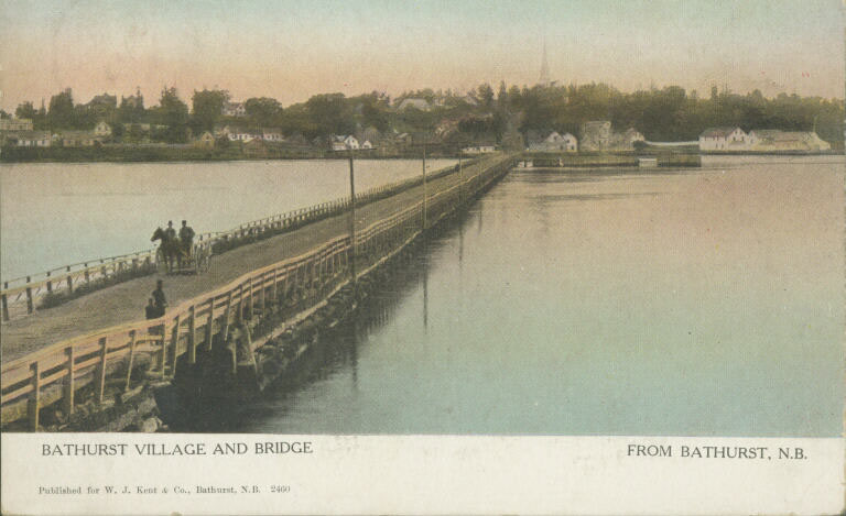 Colour postcard of narrow bridge with people, horse, wagon and wharf and town in background