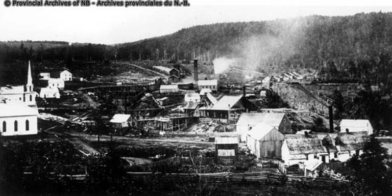 Black and white photograph of community with mine, church and employee houses