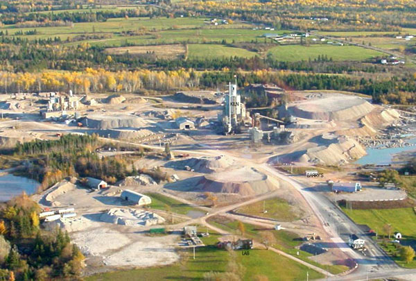 Colour aerial photograph of mine with towers, roads, buildings and piles of rock