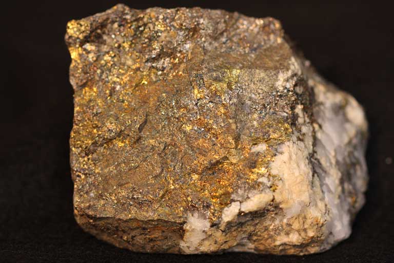Double colour image of brown rock mottled with white and yellow