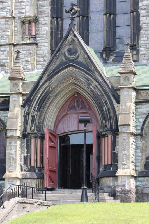 Colour photograph of stone entryway to church with red doors