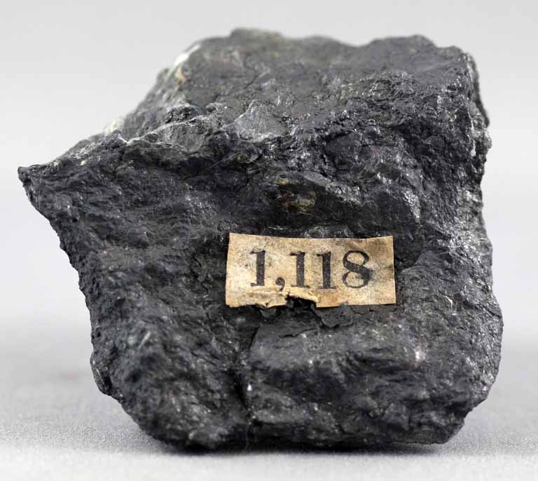 Colour image of black rock with original specimen label