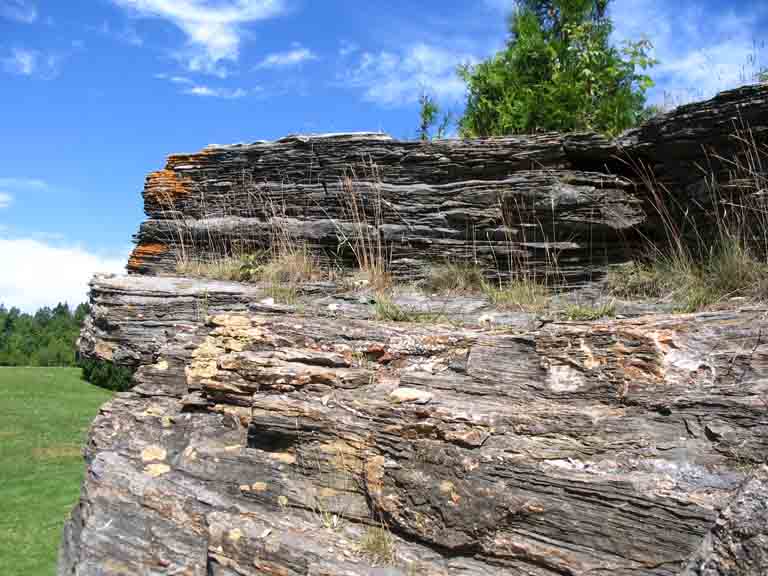 Colour photograph of gray rock with horizontal striping