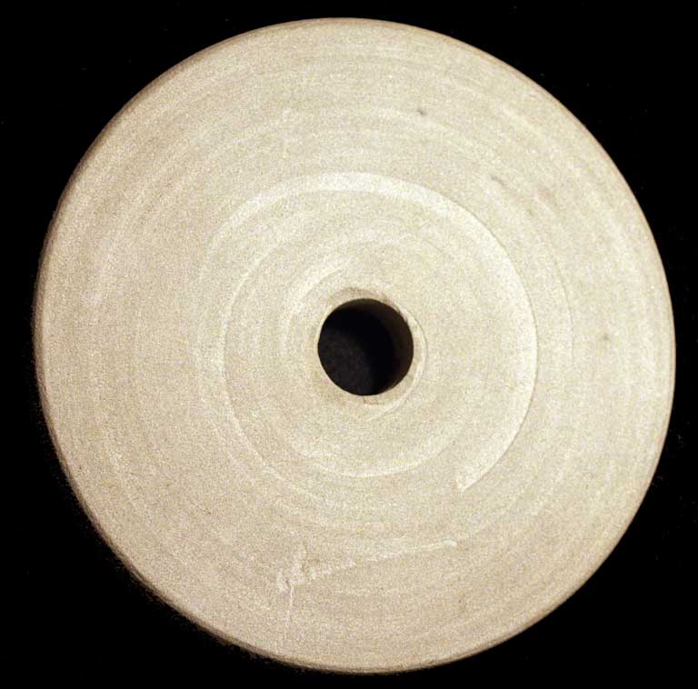 Colour photograph of a circular gray stone