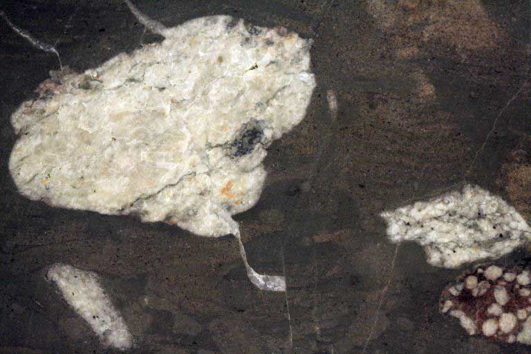 Colour image of black rock with large white spots
