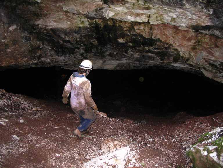 Photographie couleur d’une personne marchant dans une caverne