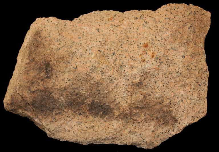 Colour image of pink rock with small white and black spots
