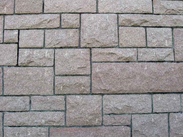 Colour photograph of rock wall with square and rectangular set stones