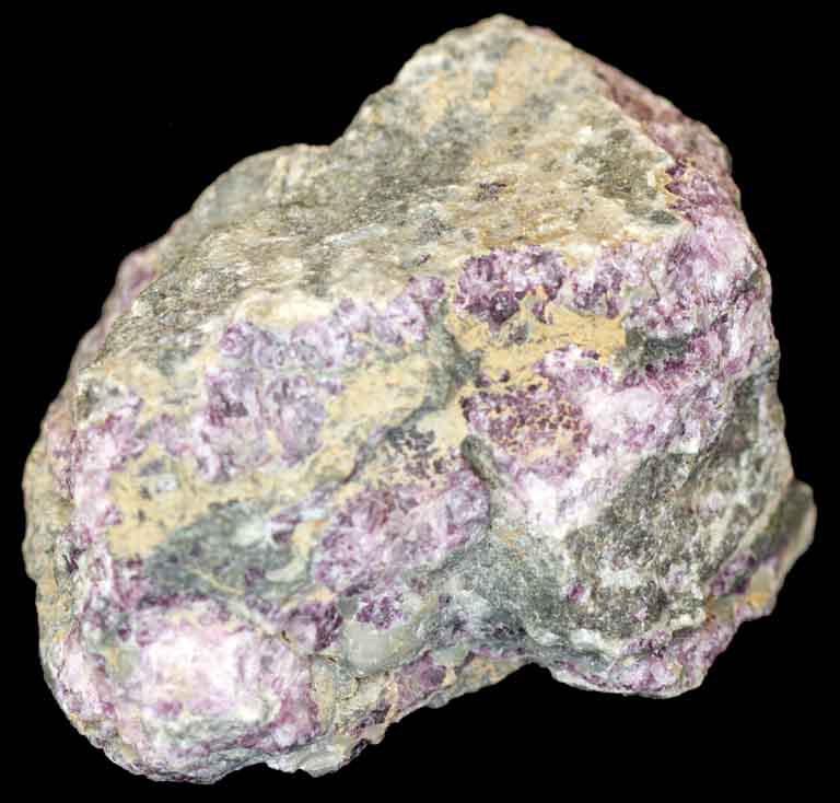 Colour image of gray rock mottled with with green, pink and yellow rock