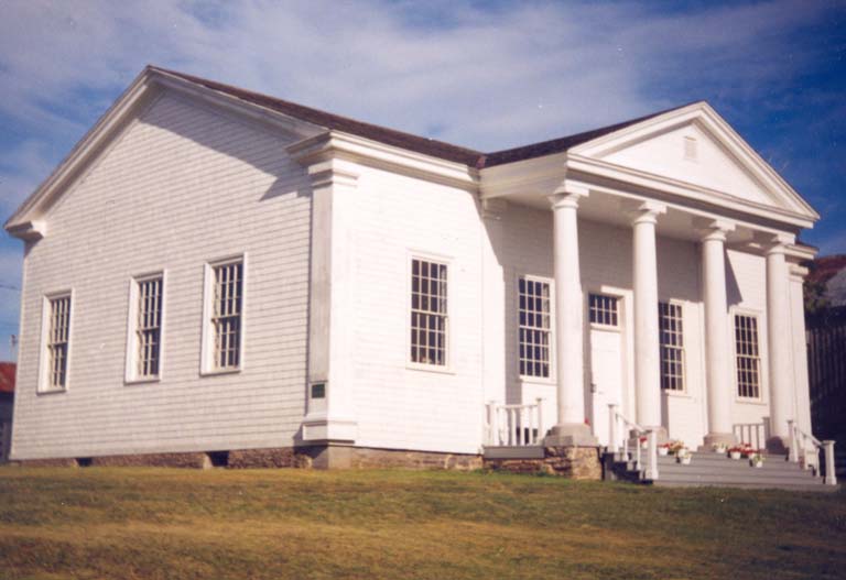 Colour photograph of large white building with four columns