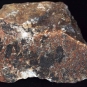 Colour image of brown rock with black, white and gray spots