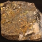 Double colour image of brown rock mottled with white and yellow