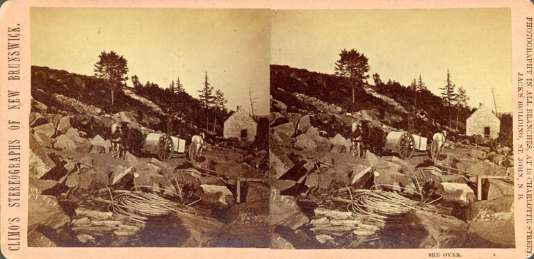 Black and white stereograph image of rock quarry with horses, wagon and building