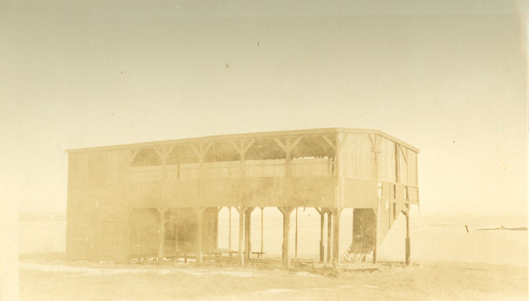 Black and white photograph of an old wooden two-storey building