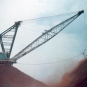 Colour photograph of a crane shovelling rock